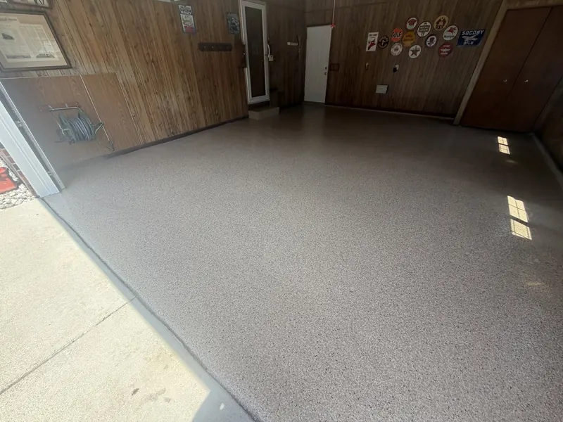 The same garage after coating with a tan flake floor and wood paneled walls