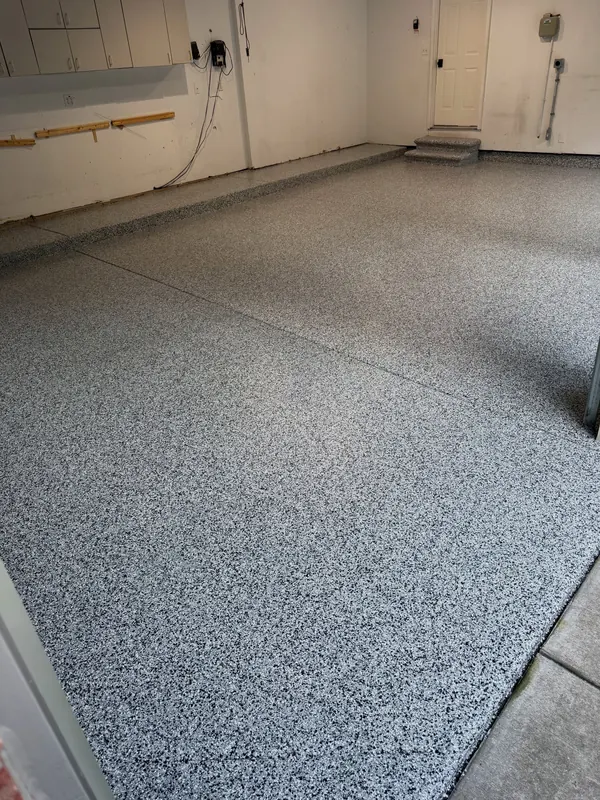 The same garage after grinding and coating with a gray full-flake floor