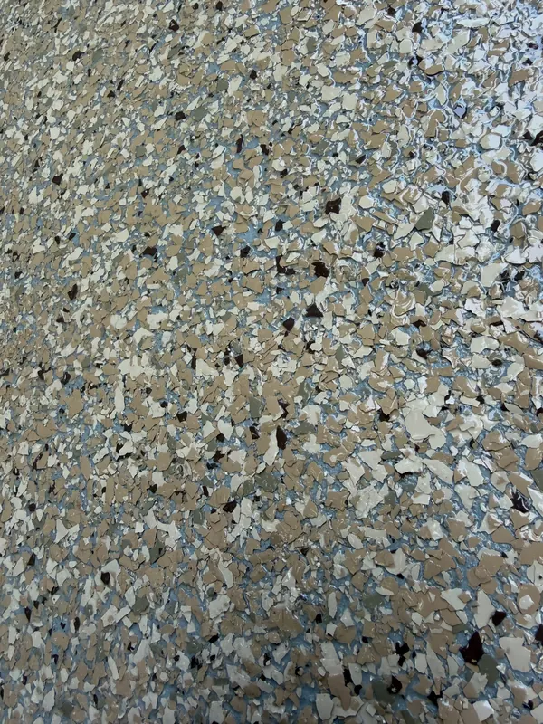 Close-up of blue, tan and black flake under a clear topcoat