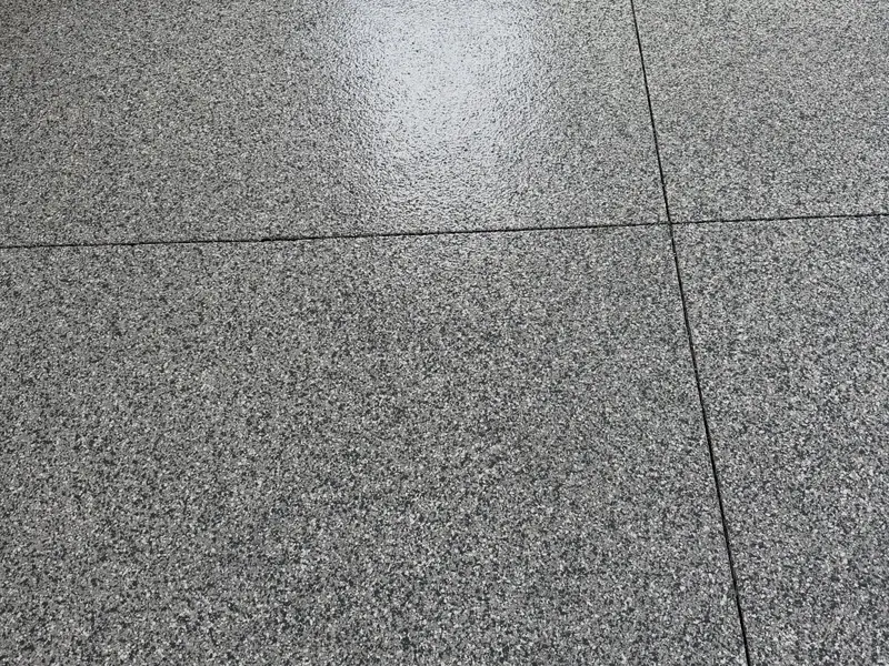 Top-down view of a finished flake floor showing the full chip broadcast under a clear topcoat