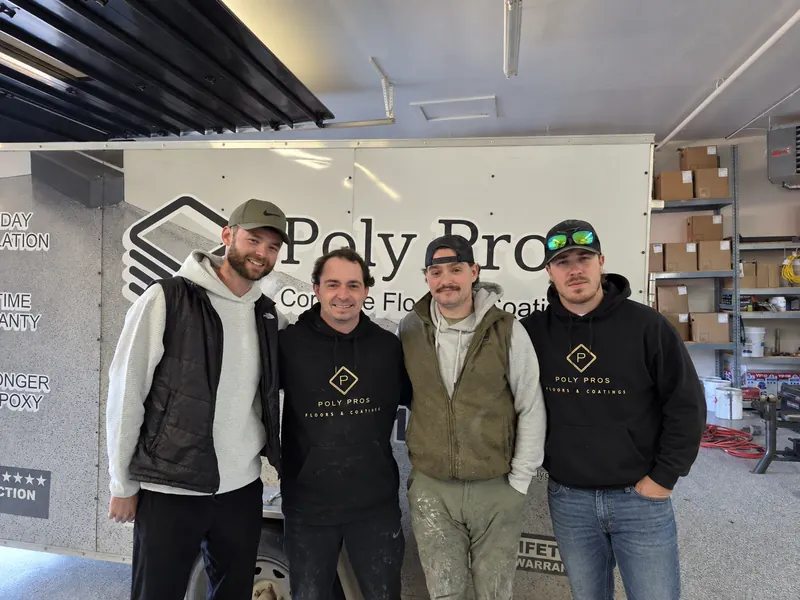 The Poly Pro's Coatings crew standing in front of a company trailer inside the shop