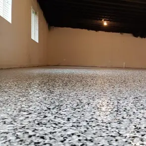 A room with a floor that has been covered in black and white spots.