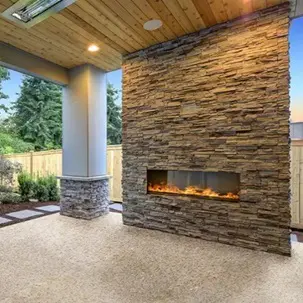 A fireplace in the middle of an outdoor patio.